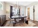 Well lit dining area with dark wood table, bench, chandelier, and an adjacent powder room at 2435 Folly Se Ln, Atlanta, GA 30339