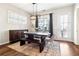 Modern dining room with dark wood table, bench, gray chairs, and large window at 2435 Folly Se Ln, Atlanta, GA 30339