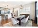 Open concept dining room featuring a decorative chandelier, modern table, and hardwood floors at 2435 Folly Se Ln, Atlanta, GA 30339