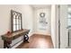 Bright entryway featuring wood floors, decorative table, mirror, and a view of the front door at 2435 Folly Se Ln, Atlanta, GA 30339