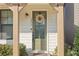 Close-up of the front door featuring a wreath, address numbers, and a covered porch at 2435 Folly Se Ln, Atlanta, GA 30339