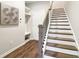 Hallway with a staircase, built-in shelves, and a door leading to another room at 2435 Folly Se Ln, Atlanta, GA 30339