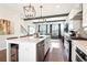 Bright kitchen with stainless steel appliances, island seating, and open floor plan at 2435 Folly Se Ln, Atlanta, GA 30339