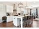 Open kitchen featuring a white island with seating, stainless steel appliances, and hardwood floors at 2435 Folly Se Ln, Atlanta, GA 30339