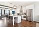 Spacious kitchen with stainless steel appliances, white cabinets, island seating, and hardwood floors at 2435 Folly Se Ln, Atlanta, GA 30339