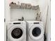 Laundry room features a new washer and dryer plus shelf storage at 2435 Folly Se Ln, Atlanta, GA 30339