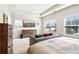 Bright main bedroom features a tray ceiling, neutral decor, and a wall-mounted flat screen tv at 2435 Folly Se Ln, Atlanta, GA 30339