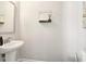 Clean powder room with pedestal sink, modern fixtures, and neutral decor at 2435 Folly Se Ln, Atlanta, GA 30339