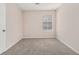 Simple bedroom with carpeted floors, a bright window, and neutral walls at 3875 Mcgill Way, Decatur, GA 30034