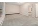 This bedroom features neutral carpet, a window, and a view to an adjacent room at 3875 Mcgill Way, Decatur, GA 30034