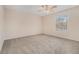 Neutral bedroom featuring a ceiling fan, carpeted floors, and a bright window at 3875 Mcgill Way, Decatur, GA 30034