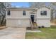 Charming two-story home with a stone foundation, tan siding, and a neatly landscaped front yard at 3875 Mcgill Way, Decatur, GA 30034