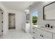 Dual vanities in a bright bathroom, featuring a glass enclosed shower with white marble surround at 648 Liella Se Park, Atlanta, GA 30312