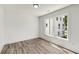 Bright bedroom featuring grey vinyl flooring, a large window, and white trim at 648 Liella Se Park, Atlanta, GA 30312