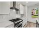 Kitchen with range, range hood, and mosaic backsplash at 648 Liella Se Park, Atlanta, GA 30312