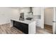 Bright kitchen featuring white cabinets, a stainless steel hood, and a large island at 648 Liella Se Park, Atlanta, GA 30312