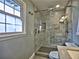 Modern bathroom with a glass-enclosed shower featuring marble tile and built-in shelving at 7440 Princeton Trce, Sandy Springs, GA 30328