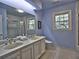 Spacious bathroom with double vanity, skylight, and a separate tub and shower at 7440 Princeton Trce, Sandy Springs, GA 30328