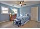 Bright bedroom with light blue walls and a ceiling fan over the bed at 7440 Princeton Trce, Sandy Springs, GA 30328