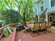 Outdoor dining area on a spacious deck with seating for six, offering a tranquil view of the wooded surroundings at 7440 Princeton Trce, Sandy Springs, GA 30328