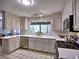 Bright kitchen with white cabinetry, stainless steel appliances, and tile flooring at 7440 Princeton Trce, Sandy Springs, GA 30328