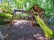 A large wooden playground featuring a slide, climbing wall, and swings, perfect for to enjoy outdoor fun at 7440 Princeton Trce, Sandy Springs, GA 30328