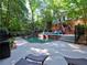 An inviting in-ground pool with surrounding deck space for lounging and a lush, private backyard setting at 7440 Princeton Trce, Sandy Springs, GA 30328