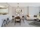 Cozy dining area with stylish light fixture, table, and seamless transition to the living room at 1101 Juniper Ne St # 722, Atlanta, GA 30309