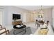Comfortable living room featuring a modern TV, dining area, and seamless transition to the kitchen at 1101 Juniper Ne St # 722, Atlanta, GA 30309