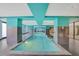 An indoor pool featuring a turquoise ceiling, gray walls, and stone flooring at 1101 Juniper Ne St # 722, Atlanta, GA 30309