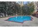 Outdoor swimming pool with lounge chairs and lush greenery, perfect for relaxation at 1101 Juniper Ne St # 722, Atlanta, GA 30309