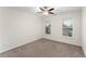 This bedroom features a ceiling fan, neutral paint, carpet, and natural light at 1658 Duncan Nw Dr, Atlanta, GA 30318