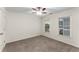 Cozy bedroom featuring carpeted floors, a ceiling fan and sunlit windows with blinds at 1658 Duncan Nw Dr, Atlanta, GA 30318