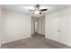 Neutral bedroom features carpeted floors, a ceiling fan and a wall of closets for storage at 1658 Duncan Nw Dr, Atlanta, GA 30318