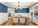 Beautiful dining room featuring wainscoting, modern light fixture, and lots of light, creating an elegant space at 1658 Duncan Nw Dr, Atlanta, GA 30318