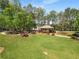 Community green space featuring a covered gazebo with picnic tables surrounded by trees and a walking path at 1658 Duncan Nw Dr, Atlanta, GA 30318