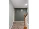 Upstairs hallway with carpet, gray accent wall, and a wooden railing at 1658 Duncan Nw Dr, Atlanta, GA 30318