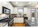 Well-equipped kitchen features stainless steel appliances, granite countertops, and backyard access at 1658 Duncan Nw Dr, Atlanta, GA 30318