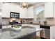 This modern kitchen features granite countertops, stainless steel appliances, and white cabinets at 1658 Duncan Nw Dr, Atlanta, GA 30318