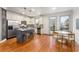 Open-concept kitchen and dining area with a stainless steel refrigerator and hardwood floors at 1658 Duncan Nw Dr, Atlanta, GA 30318