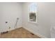 A bright laundry room features vinyl flooring, neutral paint, and a window at 1658 Duncan Nw Dr, Atlanta, GA 30318