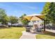 Outdoor seating area with modern chairs and tables under a shade structure near community homes and a paved path at 1658 Duncan Nw Dr, Atlanta, GA 30318