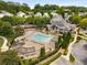 Aerial view of the community pool, clubhouse, and lush greenery at 1658 Duncan Nw Dr, Atlanta, GA 30318