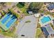 Aerial view of the community amenities showcasing the pool, tennis courts, and playground at 340 Ruby Forest Pkwy, Suwanee, GA 30024