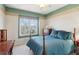 Cozy bedroom featuring a window view, complemented by a ceiling fan and a classic four-poster bed at 340 Ruby Forest Pkwy, Suwanee, GA 30024