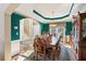 Formal dining room featuring elegant lighting, hardwood floors, and detailed trim work at 340 Ruby Forest Pkwy, Suwanee, GA 30024