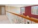 Hallway with white railing overlooking the house, two windows bringing in natural light at 340 Ruby Forest Pkwy, Suwanee, GA 30024