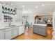 Well-lit kitchen with grey cabinets, stainless steel appliances, and an island at 340 Ruby Forest Pkwy, Suwanee, GA 30024