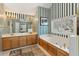 Bathroom boasts a large soaking tub, a double sink vanity, and large mirrors at 340 Ruby Forest Pkwy, Suwanee, GA 30024