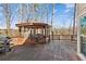 Spacious wooden deck featuring an outdoor gazebo with seating, ideal for relaxation and entertaining in a natural setting at 340 Ruby Forest Pkwy, Suwanee, GA 30024